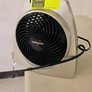 Vornado desk fan. Features a beige housing and black front grill.