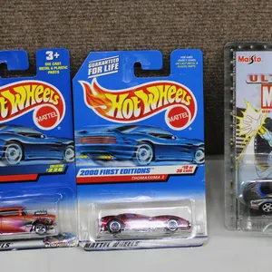 Hot Wheels '57 Chevy, Thomassima III, and Maisto Ultimate Marvel Storm Die-Cast Cars, Packaged