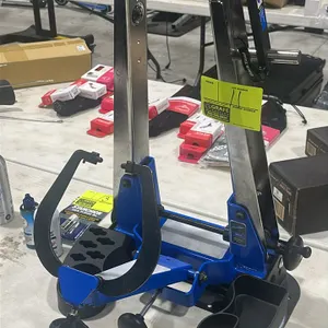 Park Tool TS-4.2 professional wheel truing stand. Features a blue and silver metal frame, adjustment knobs, and a mounted parts tray base.