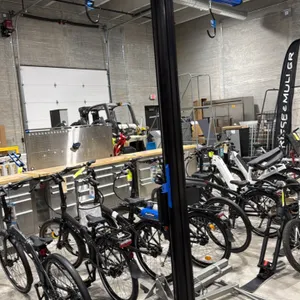 2022 Park Tool PRS-33.2 power lift bicycle repair stand. Features an electric lift system with control panel, integrated tool tray, overhead support a