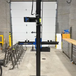 2021 Park Tool PRS-33.2 power lift bicycle repair stand. Features up/down control panel, tool trays, adjustable clamp, and top bar with hanging hooks.
