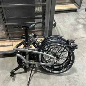 Tern 11-speed folding bicycle. Features a silver-tone folding frame, Ergon saddle, front and rear fenders, and a rear rack with transport wheels. Equi