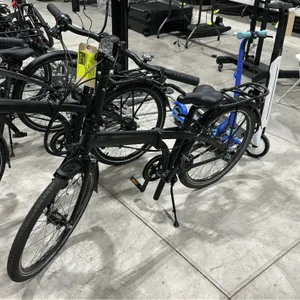Tern Node D7i folding bicycle. Features a black frame, front headlight, rear cargo rack, front and rear fenders, and a kickstand.