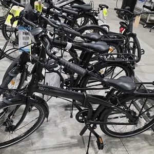 Tern Node D7i folding bicycle. Features a 7-speed Shimano Nexus shifter, front headlight, rear cargo rack, front and rear fenders, and a kickstand. Ma