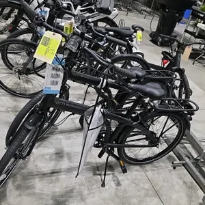 Tern Node D7i folding bicycle. Features a 7-speed shifter, headlight, rear rack, fenders, and kickstand. Finished in black and brown. Frame Number: AA