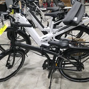 Tern Node D7i folding bicycle. Features a black finish, 7-speed gearing, folding frame and pedals, front headlight, rear cargo rack, front and rear fe