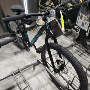 Radio Bike Co. Zuma 24 bicycle. Features a black frame with blue lettering, rigid fork, disc brakes, and knobby tires.