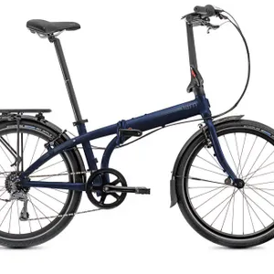 Tern Node D8 8-speed folding bicycle. Features a midnight blue and gray frame with 24" wheels. Includes front and rear fenders, a rear cargo rack, and
