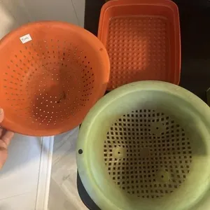 Plastic strainers and rectangle Tupperware bowl