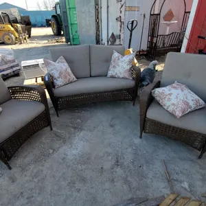 Wicker Patio Furniture Set with Gray Cushions and Floral Throw Pillows, Three Pieces