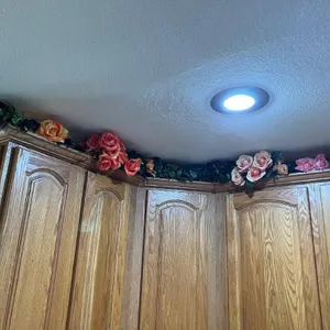 Artificial Roses on top of Kitchen Cabinets