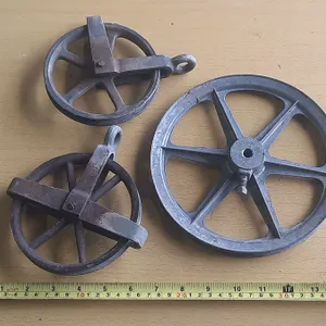 Antique industrial cast iron pulley wheels.