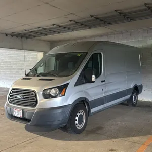 2018 Ford Transit 150 cargo van. Features a 3.7L V6 engine and automatic transmission. Silver exterior with sliding passenger-side door and dual rear 