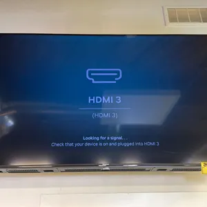 HISENSE TV MOUNTED TO WALL WITH POWER CORD & REMOTE