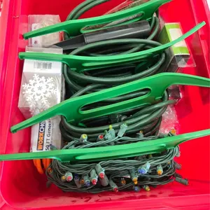 Red tote of Christmas lughts and ext cords