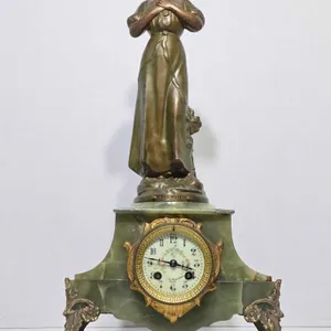 "Les Bois" (The Woods) signed J. Donaint, depicts a beautiful barefooted woman, on a Green Onyx base, pressing a bird to her bosom. This lovel