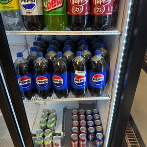 LOT OF BOTTLED AND CANNED SODA LOCATED IN REFRIGERATOR