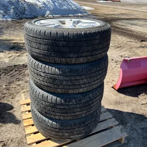 4- P285/45R22 Tires On Chev Rims W/ Center Caps