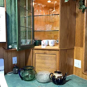 ALL ITEMS IN THE CORNER KITCHEN CUPBOARD INCLUDING:  WINE GLASSES, TEA CUPS, COFFEE CUPS, ICE BUCKET, PITCHER BOWL & TEAPOT