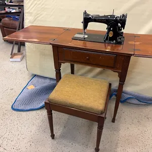 Vintage Singer sewing machine with cabinet and bench