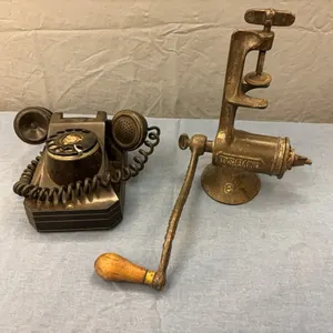 Rotary desk phone and vintage meat grinder