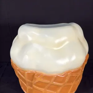 A Vanilla Ice Cream Scoop Sculpture Stool. A novelty chair designed as a scoop of vanilla ice cream in a waffle cone cup. Originally designed for the 