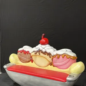 A Banana Split Sculpture Bench. Red padded seat, two cup holders, and a sculpted backrest with a banana, ice cream scoops, whipped cream, and a cherry