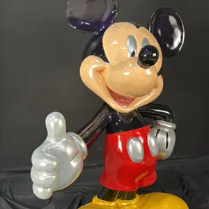 A Mickey Mouse Display Sculpture. (Disney) A display sculpture of Mickey Mouse with his right arm outstretched and left hand on his hip, painted in hi