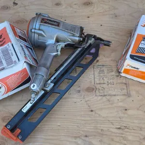 Paslode Gun with Two Boxes of Paper Tape Strip Nails