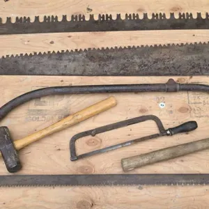 Vintage Hand Tools Including Saws, Axes, and Hammers
