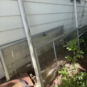 Old sliding door and other items outside of shed