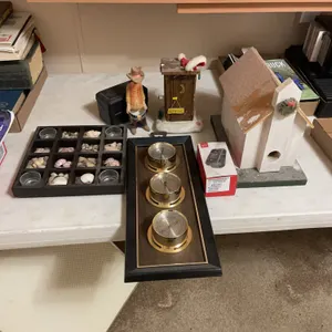 Seashell decorative candle holder, thermometer, barometer, humidity, meter, index card box, wood decorative pieces, an LGVN 170 flip phone