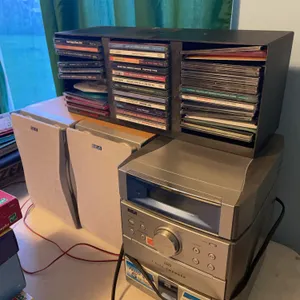 RCA radio with five disc changer, two speakers and various artist CDs