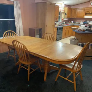 Wood table and chairs, two leaves, four chairs, 42 inches wide, 95 inches long, showing surface wear on top of the table