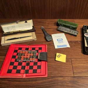 Collectible Items Including Watches, Harmonica, Calculator Keychain, Chess Set, and Pen