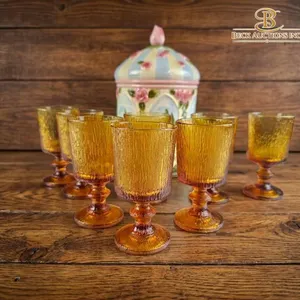 Amber Glass Goblets and Hand-Painted Ceramic Jar