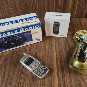 Lot Including Portable Radio, Vintage Mobile Phone, Smart Fitness Tracker Box, and LED Flashlight