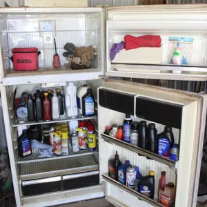Farm and Automotive Oils and Chemicals In a Non-Working Refrigerator
