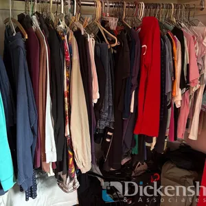 LOT OF CLOTHING IN BEDROOM CLOSET