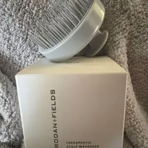Rodan + Fields Therapeutic Scalp Massager.