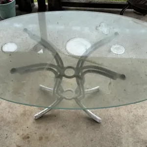 Outdoor patio table with glass top.