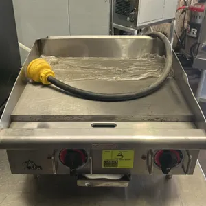 (New) Star Max 24" electric countertop griddle. Features two thermostatic control dials, stainless steel construction, splash guards, and a front grea