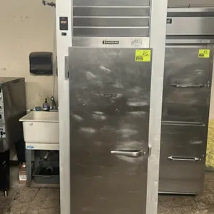 Traulsen G12011 single-door reach-in commercial freezer. Features self-contained refrigeration, stainless steel exterior, and 2 interior wire shelves.
