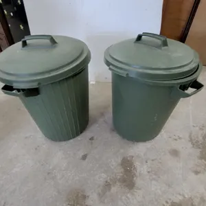 Two Green Plastic Utility Trash Cans with Ribbed Exteriors and Fitted Lids