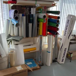 LARGE ASSORTMENT OF PRINTER MATERIAL (ROLLS), MULTIPLE STORAGE CABINETS AND BOOKSHELVES