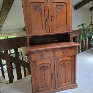 Lovely Art Nouveau Two Piece Oak Cabinet with Floral Design. This is a petite cabinet measuring 26 x 16.5 x 49. The Base piece measures 25" tall. 