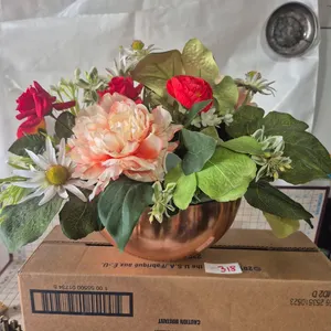 Copper pot with flower arrangement.