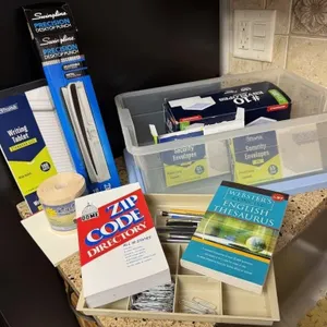 Tote of office supplies, envelopes, pens, paper