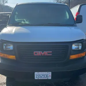 2014 GMC Savana G33705 cargo van. Features a Vortec 6.0 V8 engine, automatic transmission, and rear receiver hitch. Showing 243,699 miles. Equipped wi