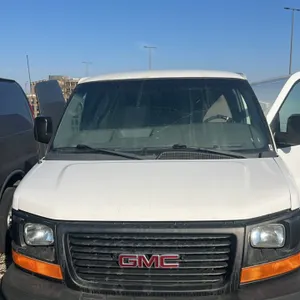 2014 GMC Savana 3500 cargo van. Features a 6.0 Vortec engine, rear cargo area with metal shelving, and partition bulkhead. Odometer: 264,589 miles. VI
